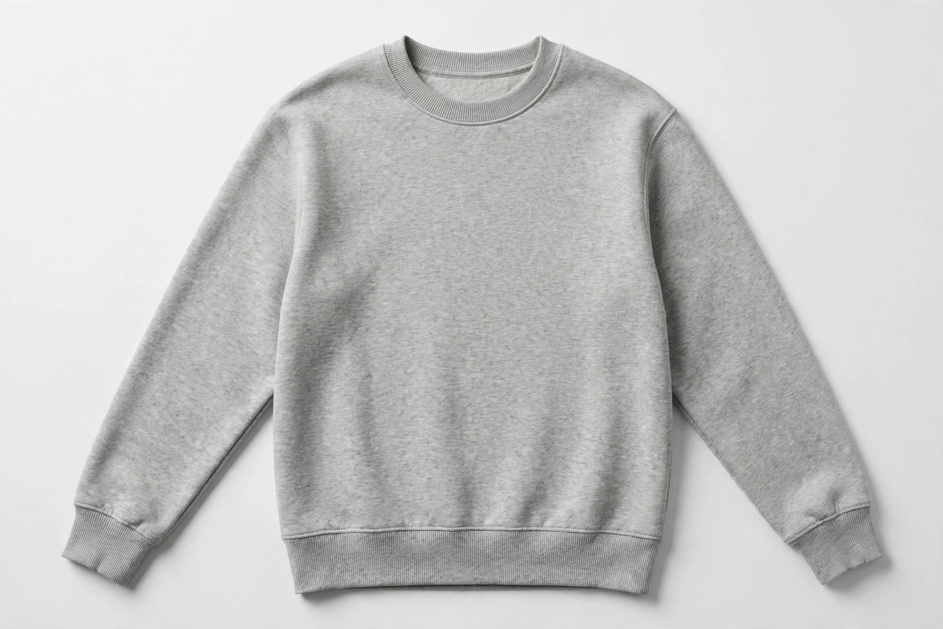 Plain unbranded crewneck sweatshirt laid flat on a light background, showing the ribbed crew collar, cuffs, and waistband